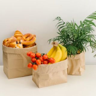 Bakery items and fruit in paper bags